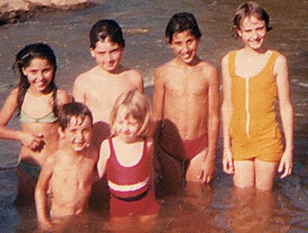 Camila Morgado, com 5 anos, de maiô vermelho, com irmãos e primos